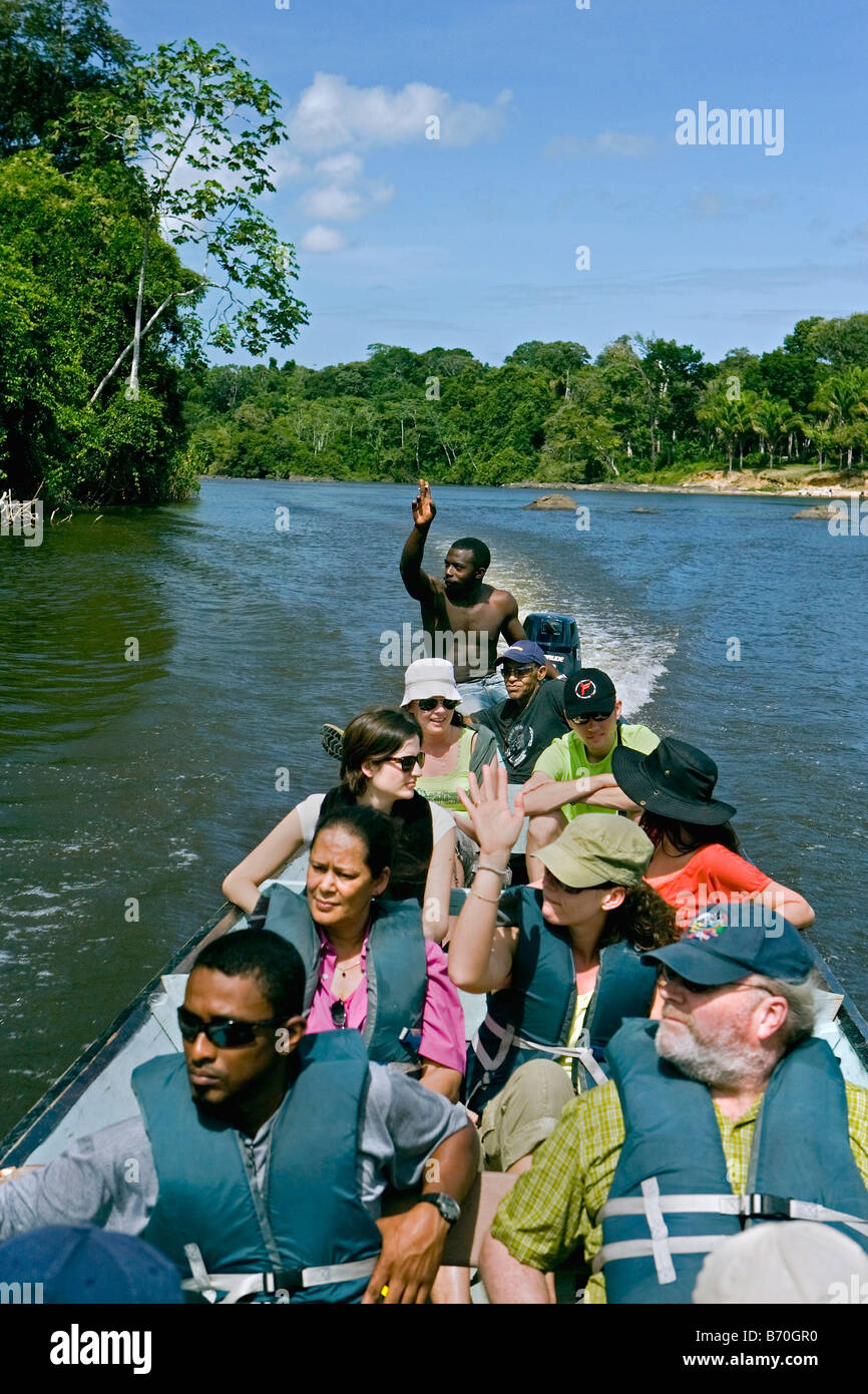 Suriname, Laduani, at the bank of the Boven Suriname river. Tourists making tour on river with dug out canoes. Stock Photo