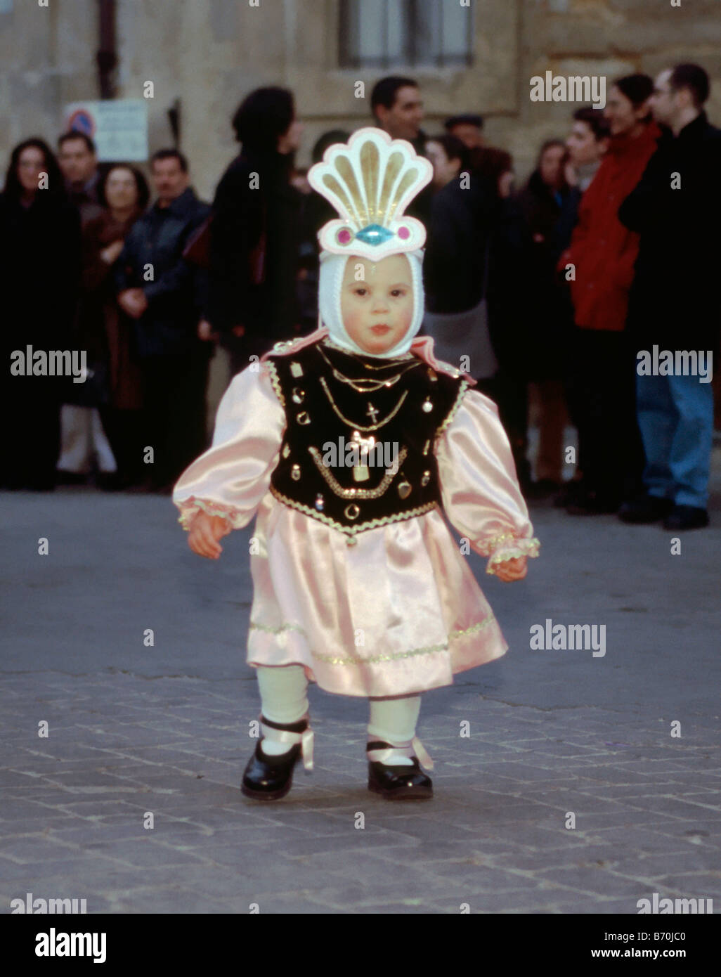 Small child dressed as angel at Settimana Santa Holy Week Procession on Palm Sunday night in Enna Sicily Italy Stock Photo