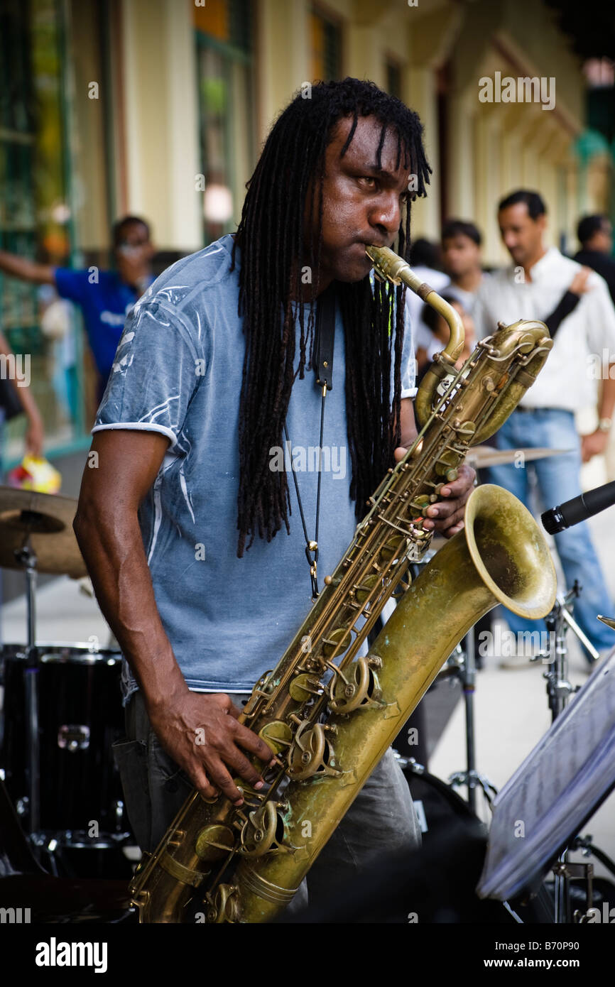 Man playing saxophone and busking at a street concert in Port Louis Mauritius Stock Photo