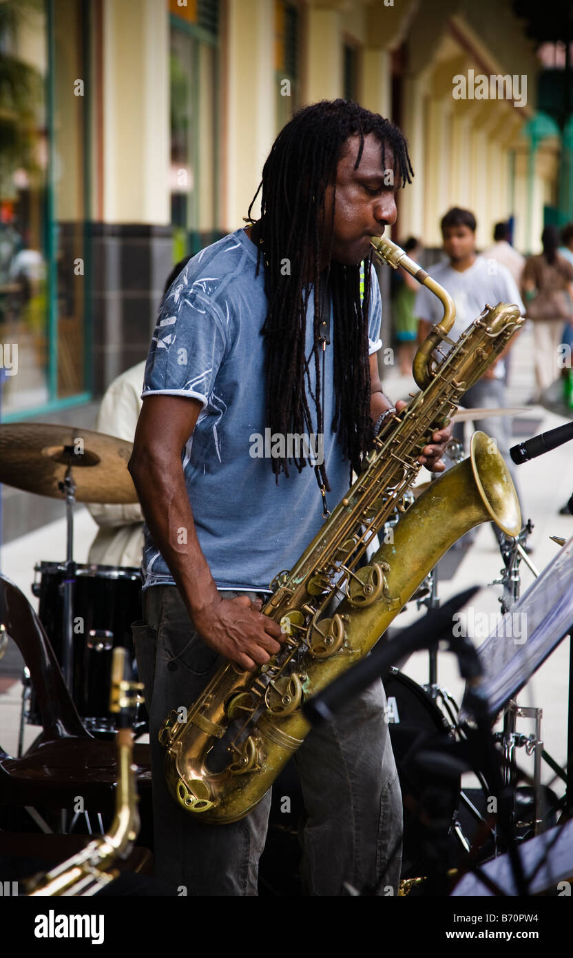 Man playing saxophone at street concert busking in Port Louis Mauritius Stock Photo