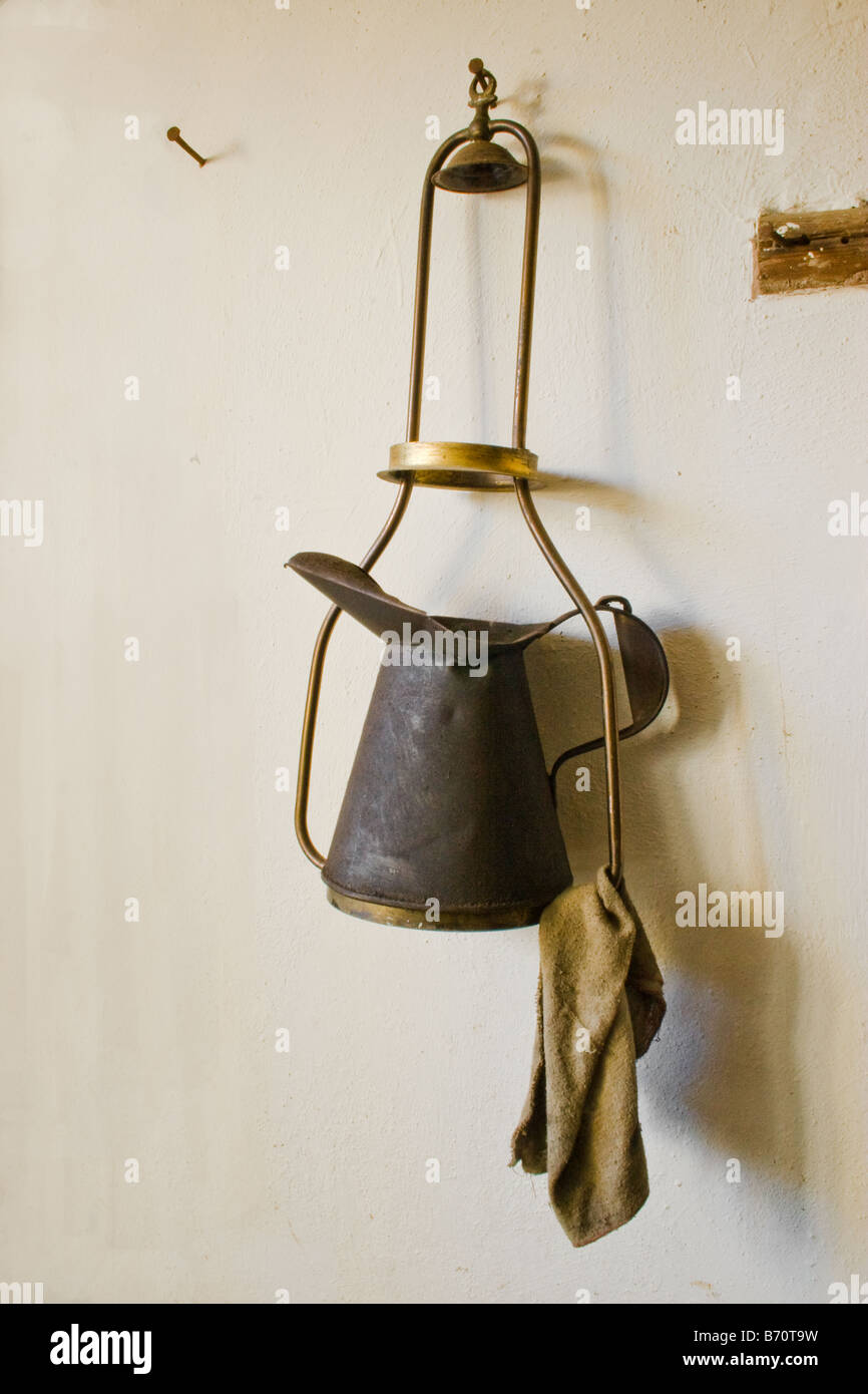 Black tin jug carrier and cloth Stock Photo