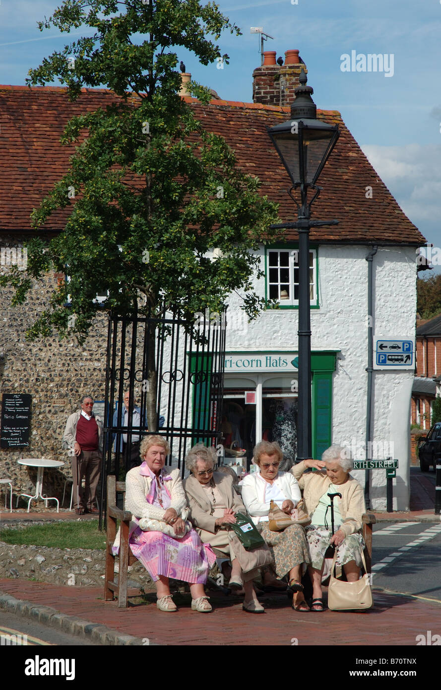 elderly ladies sitting on seat, Alfriston, East Sussex, England, UK Stock Photo
