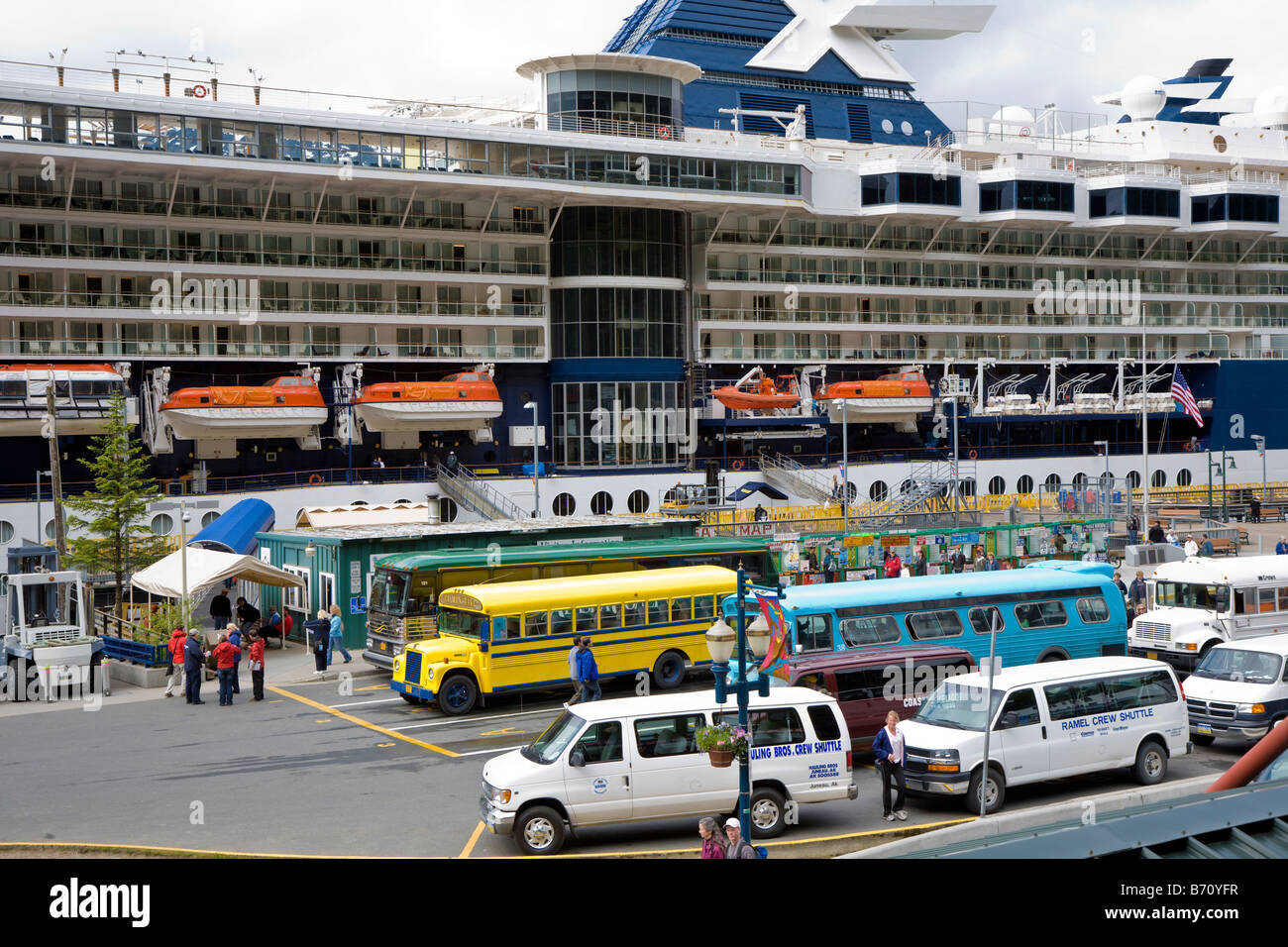 Tour busses and shuttle vans line up to carry cruise ship passengers to excursions in Juneau, Alaska Stock Photo