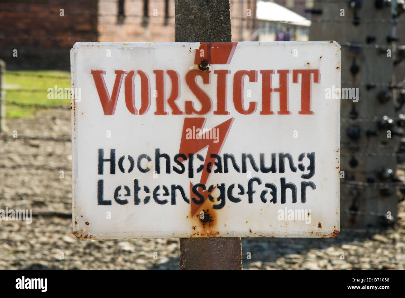 A sign that warns of high voltage and mortal danger at Auschwitz concentration camp Poland Stock Photo