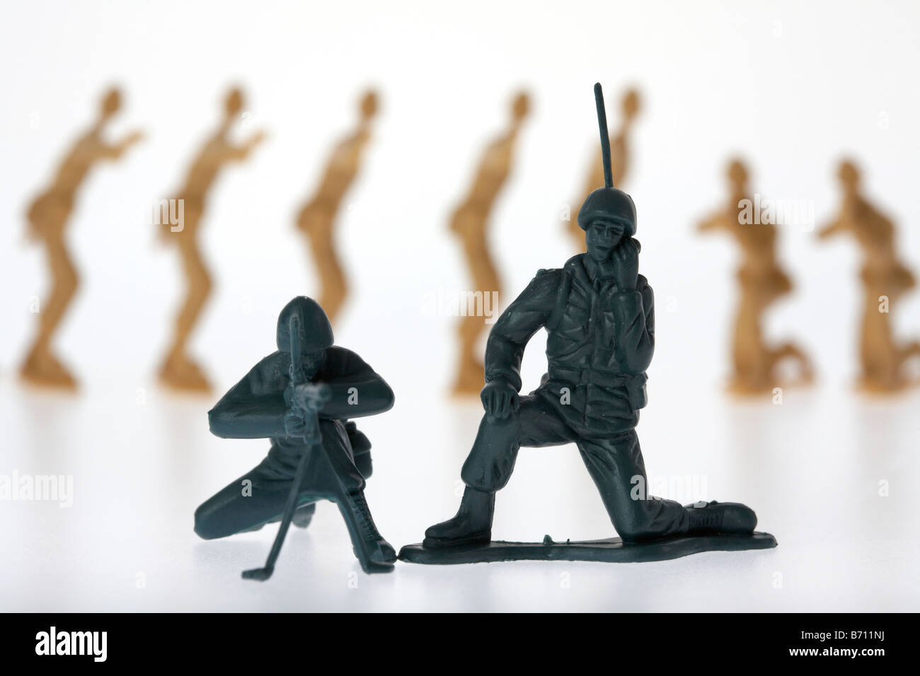 toy soldiers radio communication soldier and machine gunner oblivious to being surrounded by enemy soldiers Stock Photo