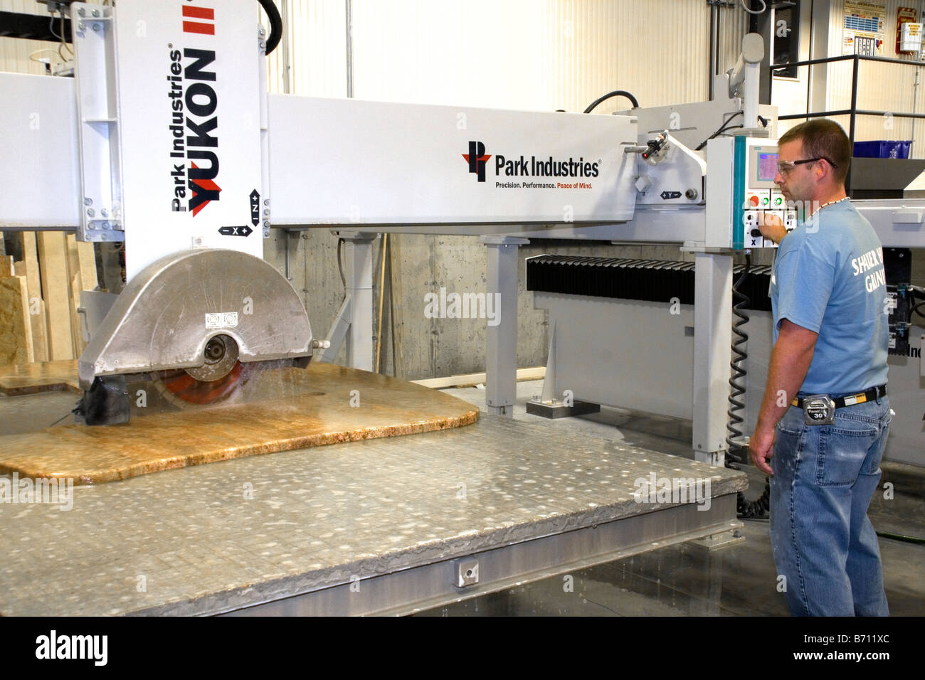 Worker custom cutting a granite countertop at the Shaker Hill Granite
