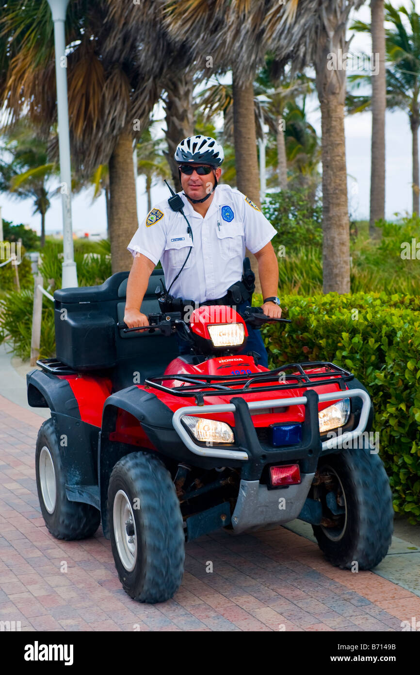 Miami South Beach Lummus Park Officer Vitores policeman on patrol on police quad bike with blue & red lights & go fast helmet Stock Photo