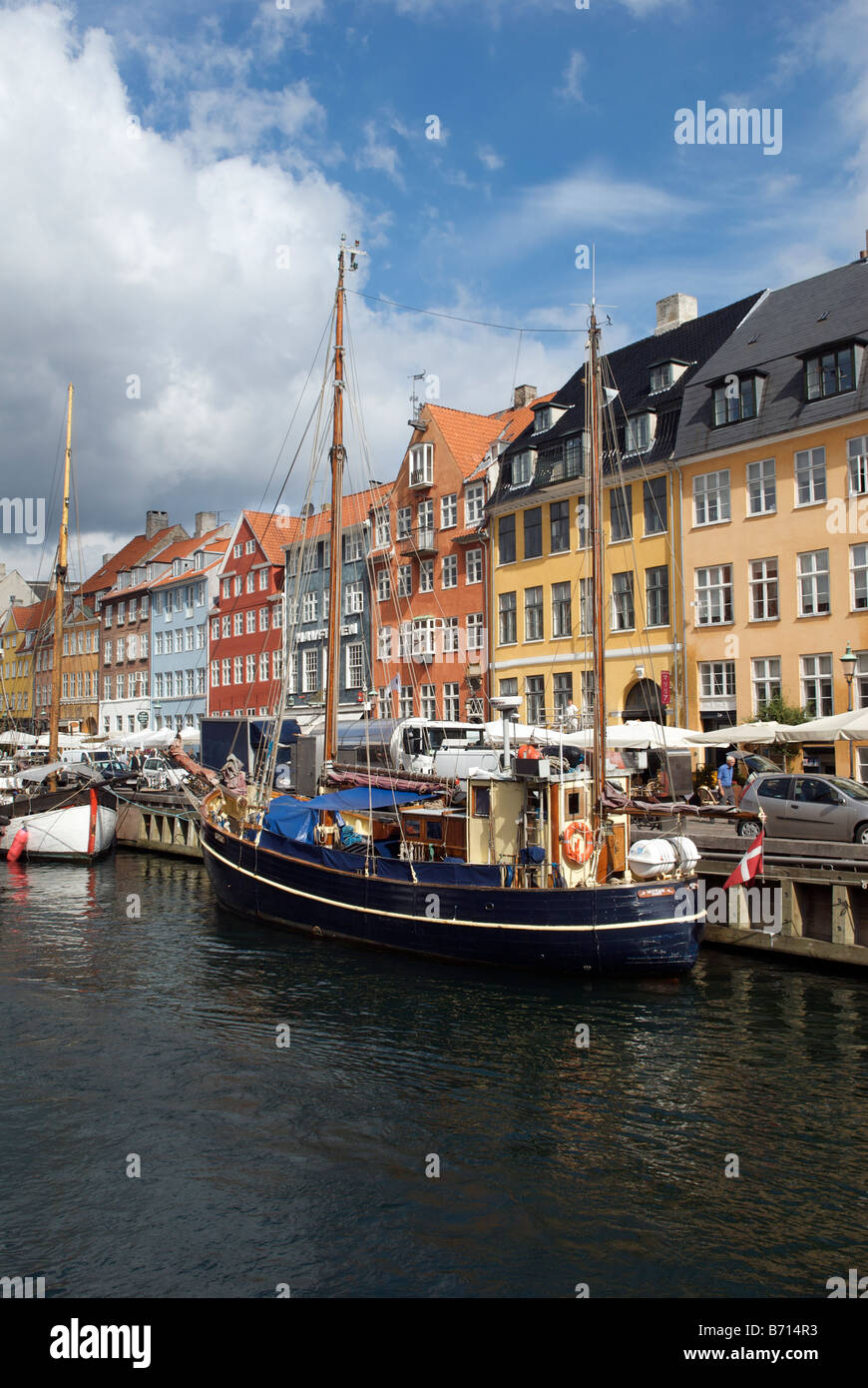 Boats and colourful buildings with waterfront cafes and restaurants Nyhavn Copenhagen Denmark Stock Photo