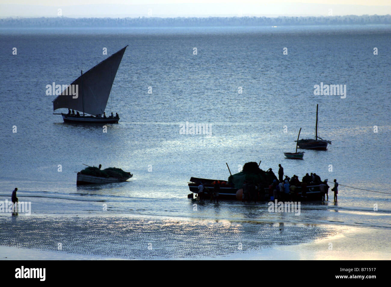 Fishermen and Fishing Boats on the island of Zanzibar in Tanzania Stock Photo