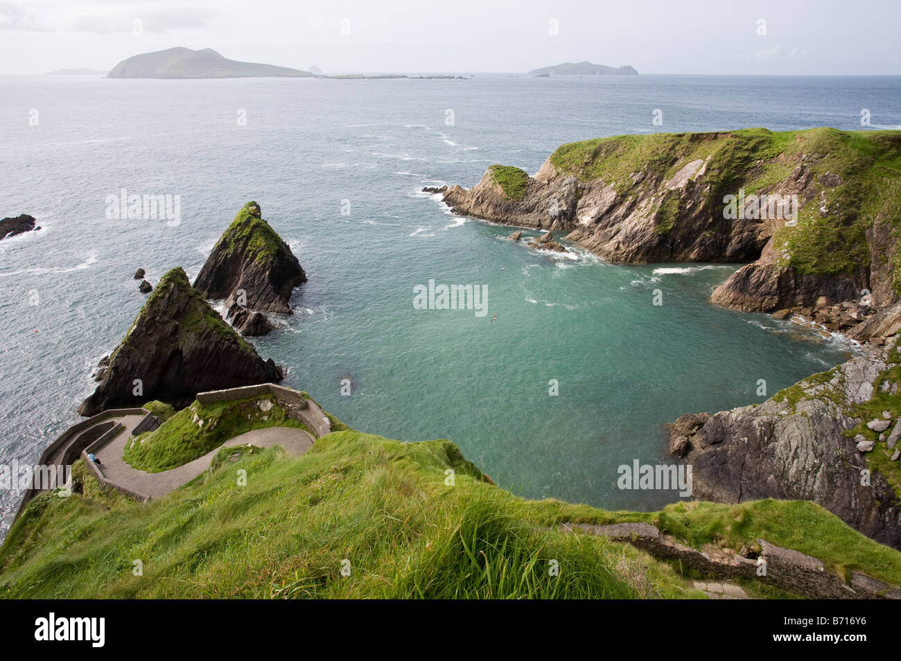 Minimal Harbour. The small partially protected harbour that serves the Blasket Islands and the winding path down to it Stock Photo