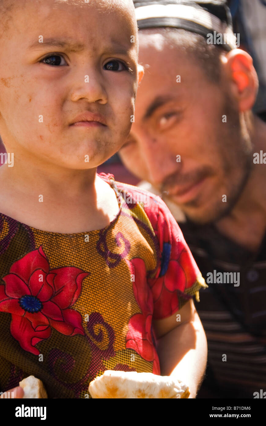 Man with daughter Kashgar Xinjiang China Stock Photo