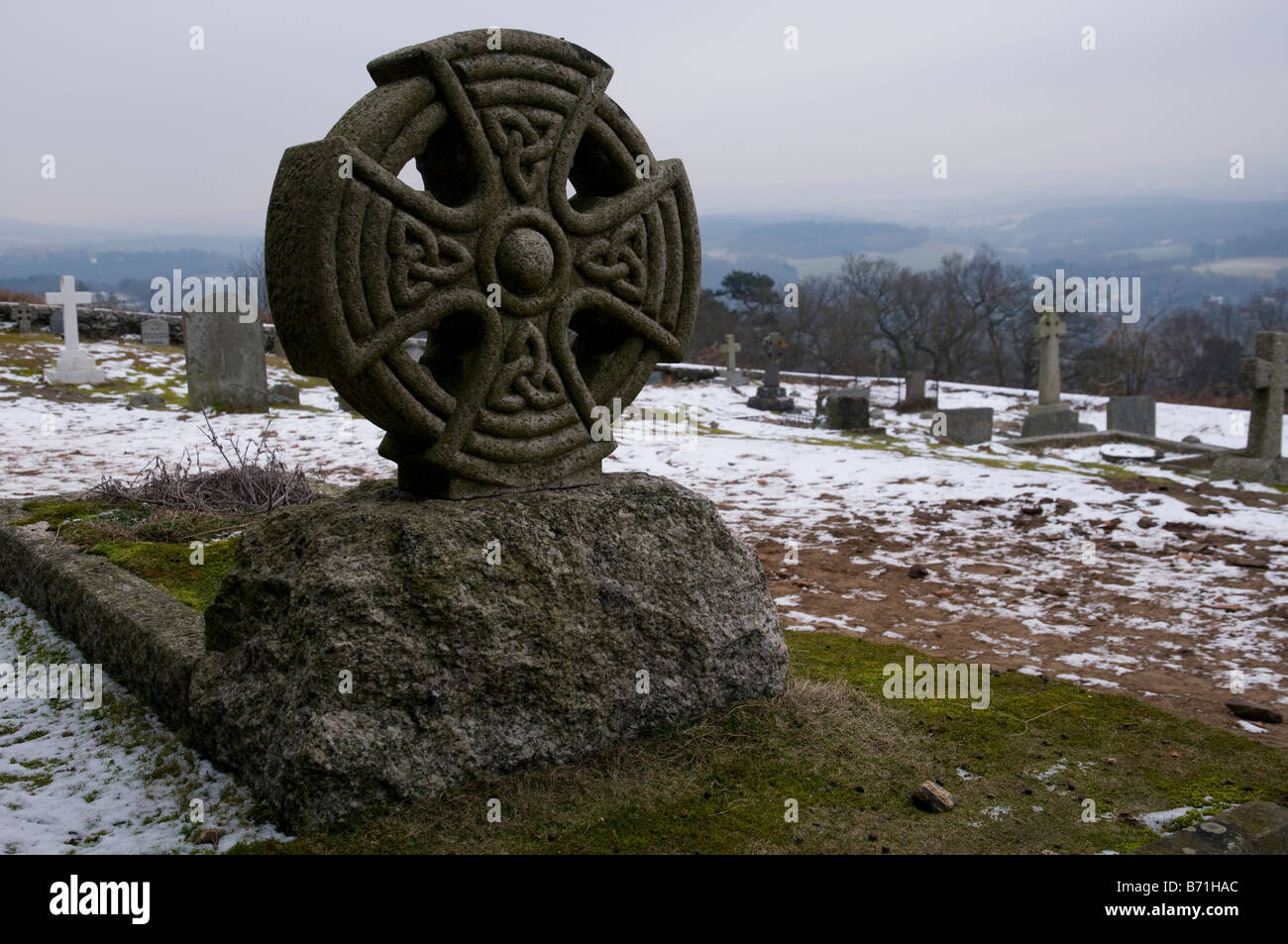 A Celtic cross gravestone at St Martha's Church near Chilworth Stock Photo