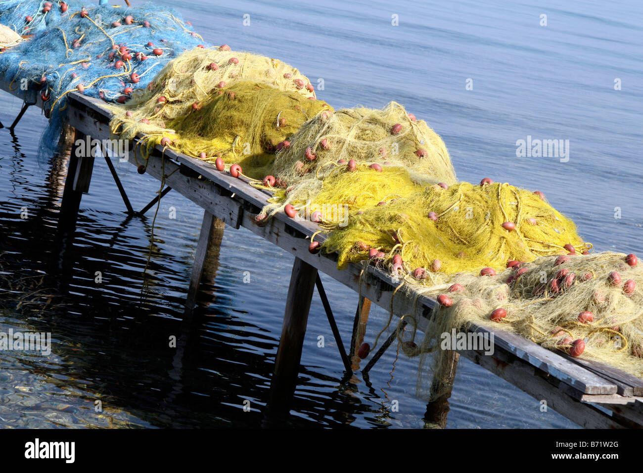 Piles of fishing nets on a jetty Stock Photo