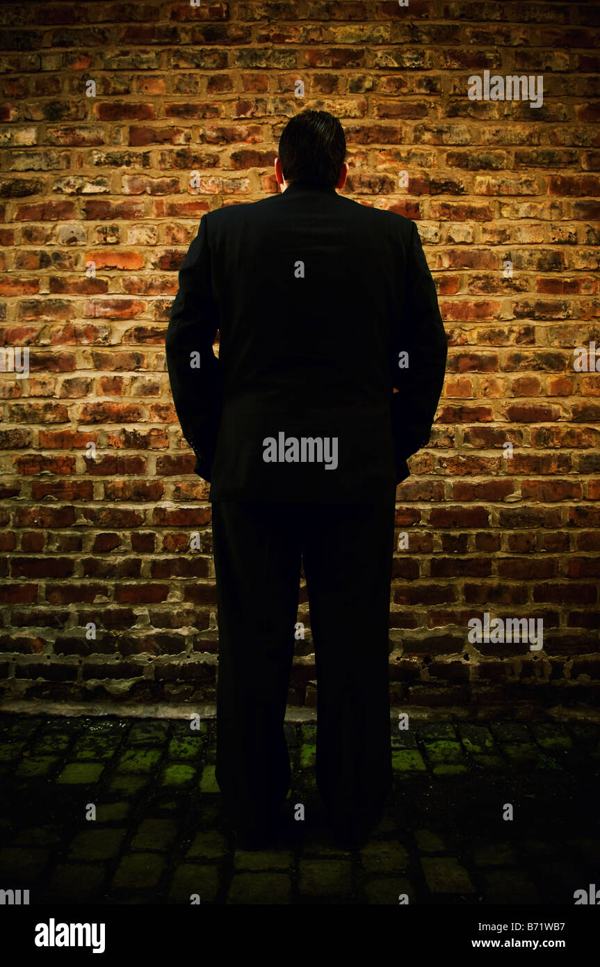 Business man facing the wall Stock Photo