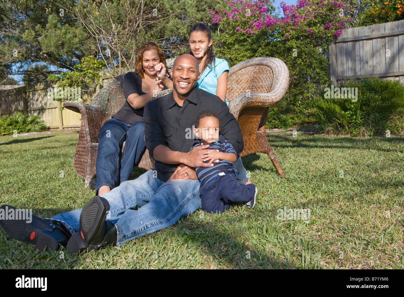 Happy African American family sitting in yard outdoors Stock Photo - Alamy