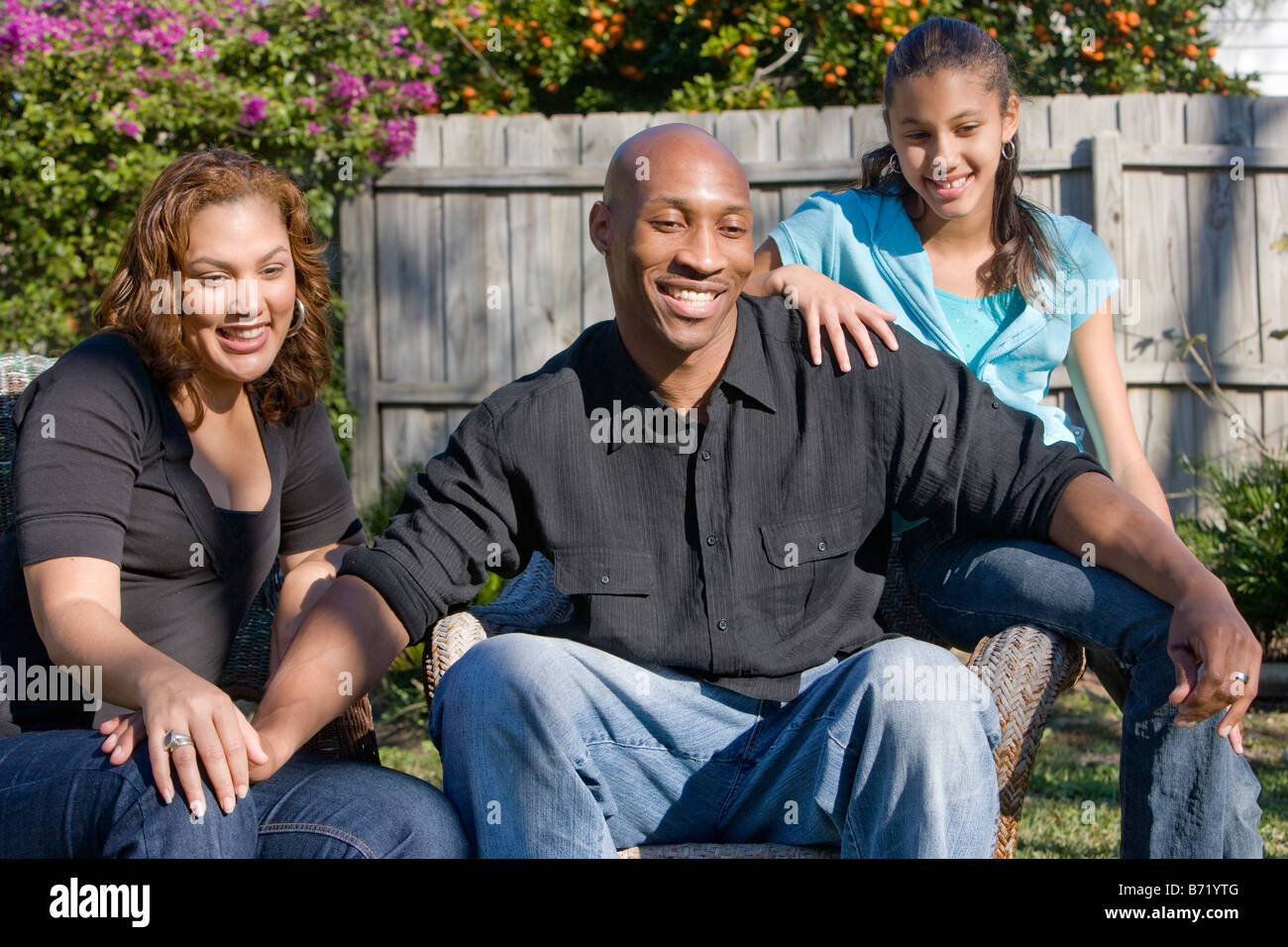 Happy African American family sitting in backyard Stock Photo - Alamy