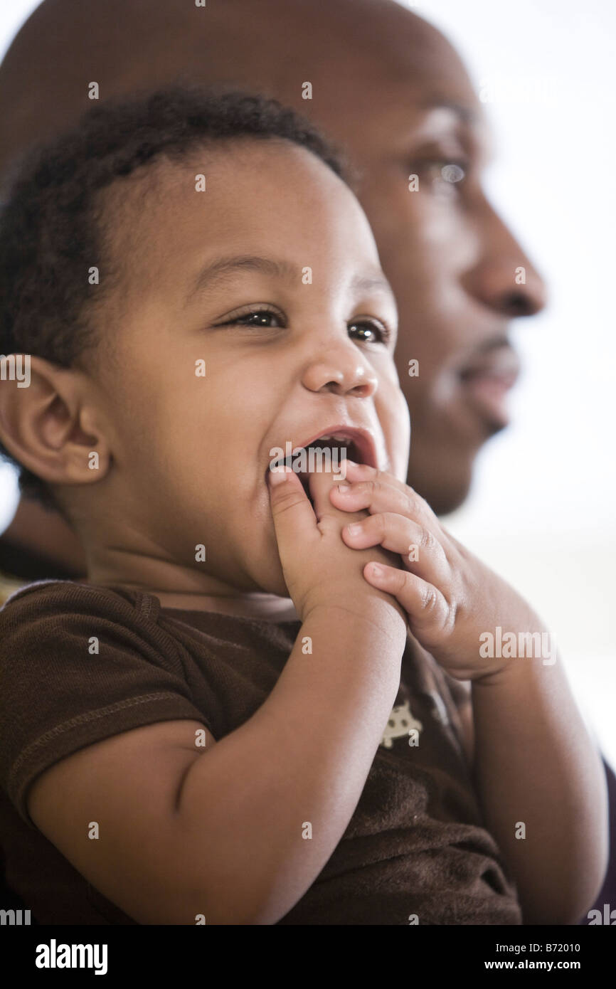 Happy African American baby boy with dad in background Stock Photo Alamy