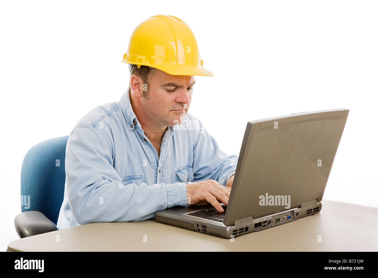 Construction contractor in the office on his laptop Isolated on white ...