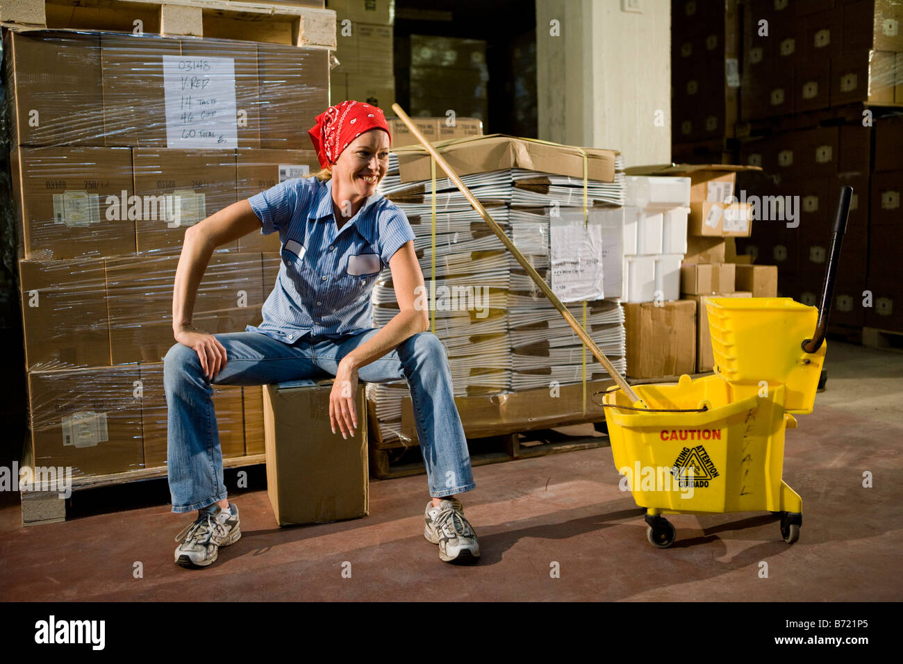Janitor with mop bucket in storage warehouse Stock Photo - Alamy