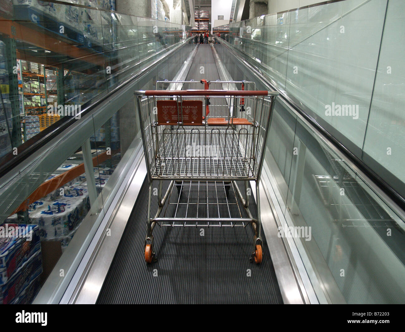 An empty shopping card rides the up escalator at a Costco Wholesale big