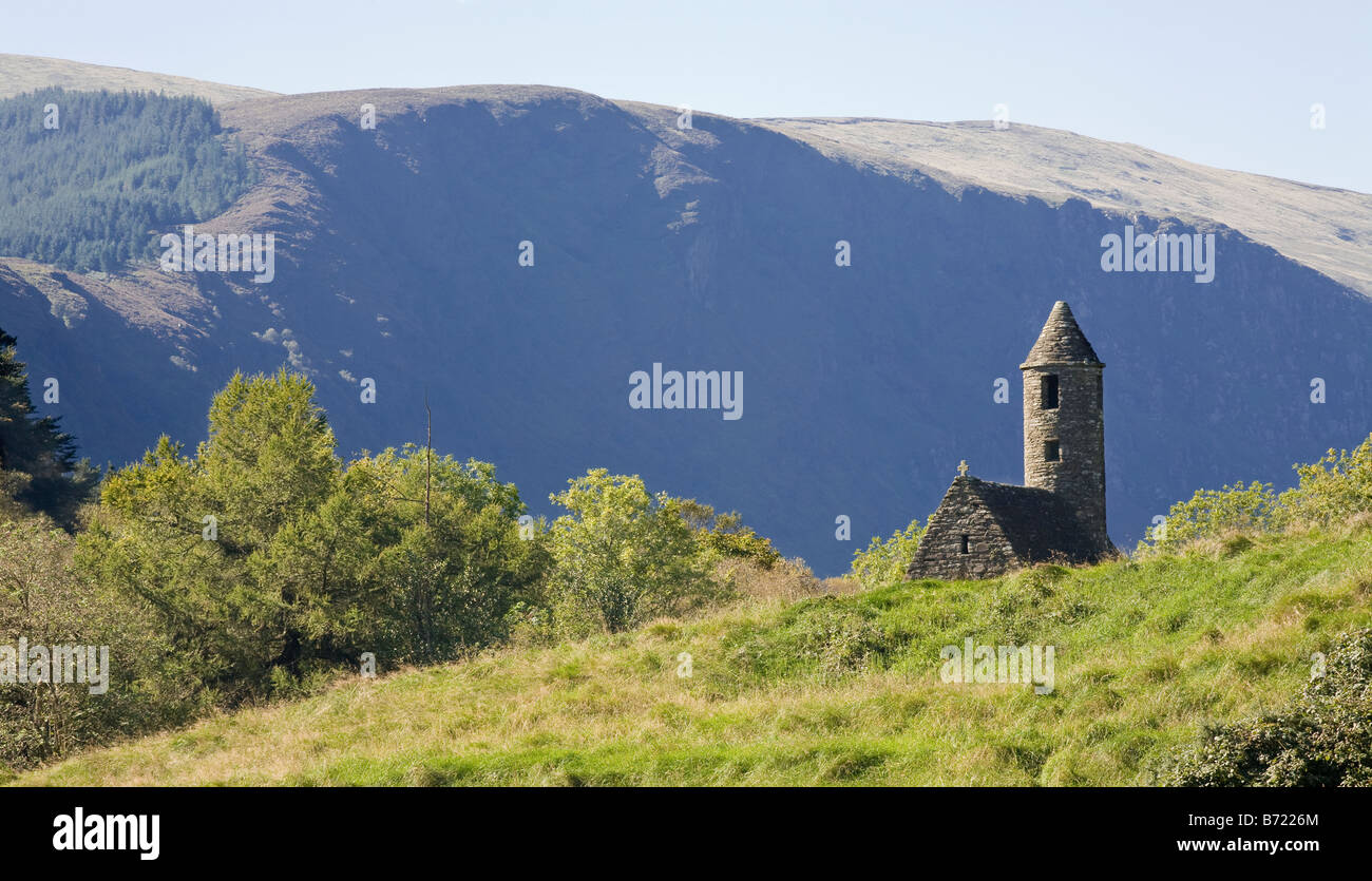 St Kevin's Chapel. The round tower sets this small stone chapel apart from the other buildings at Glendalough Stock Photo