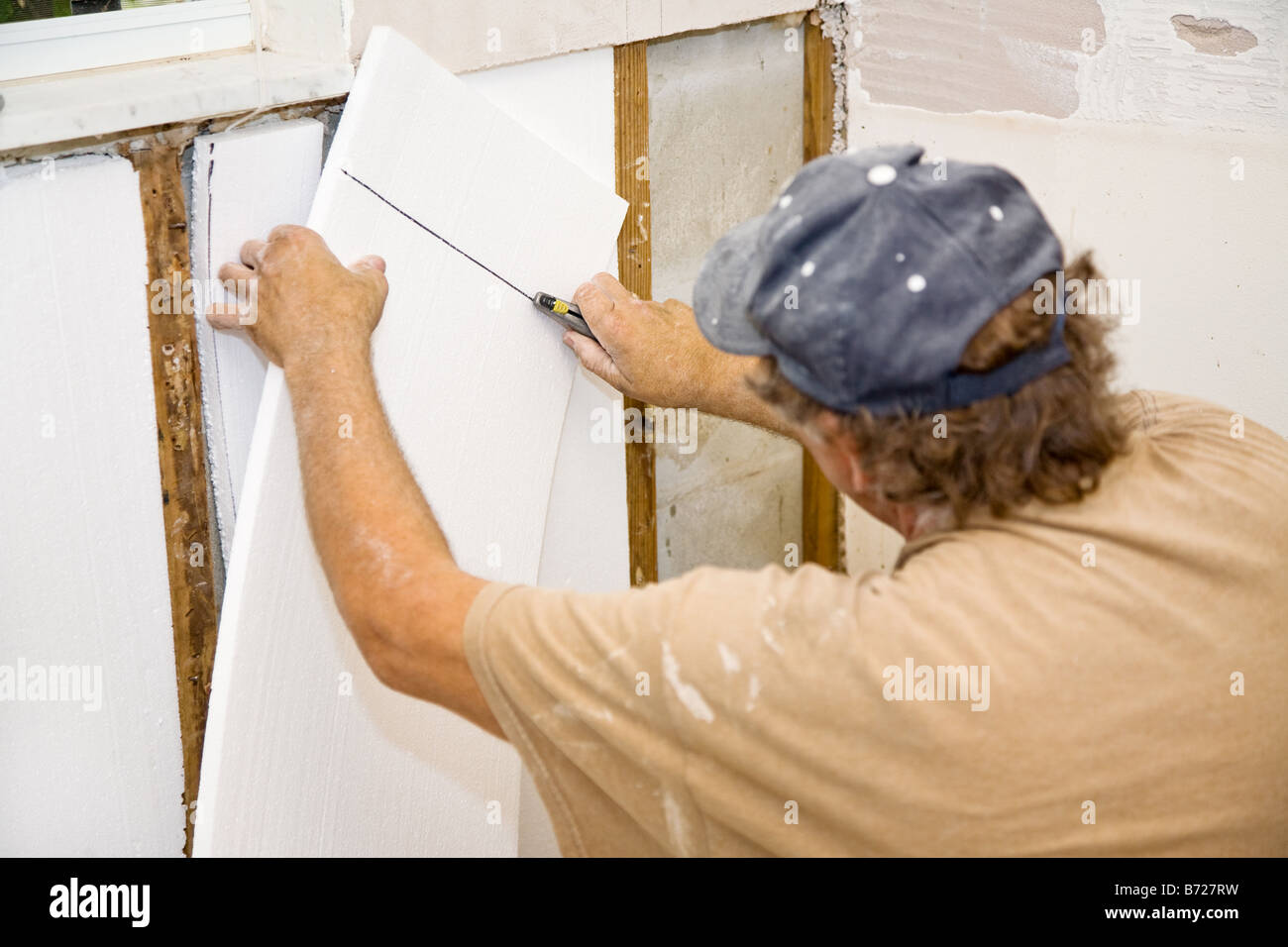 Contractor Installing Styrofoam Insulation In An Interior