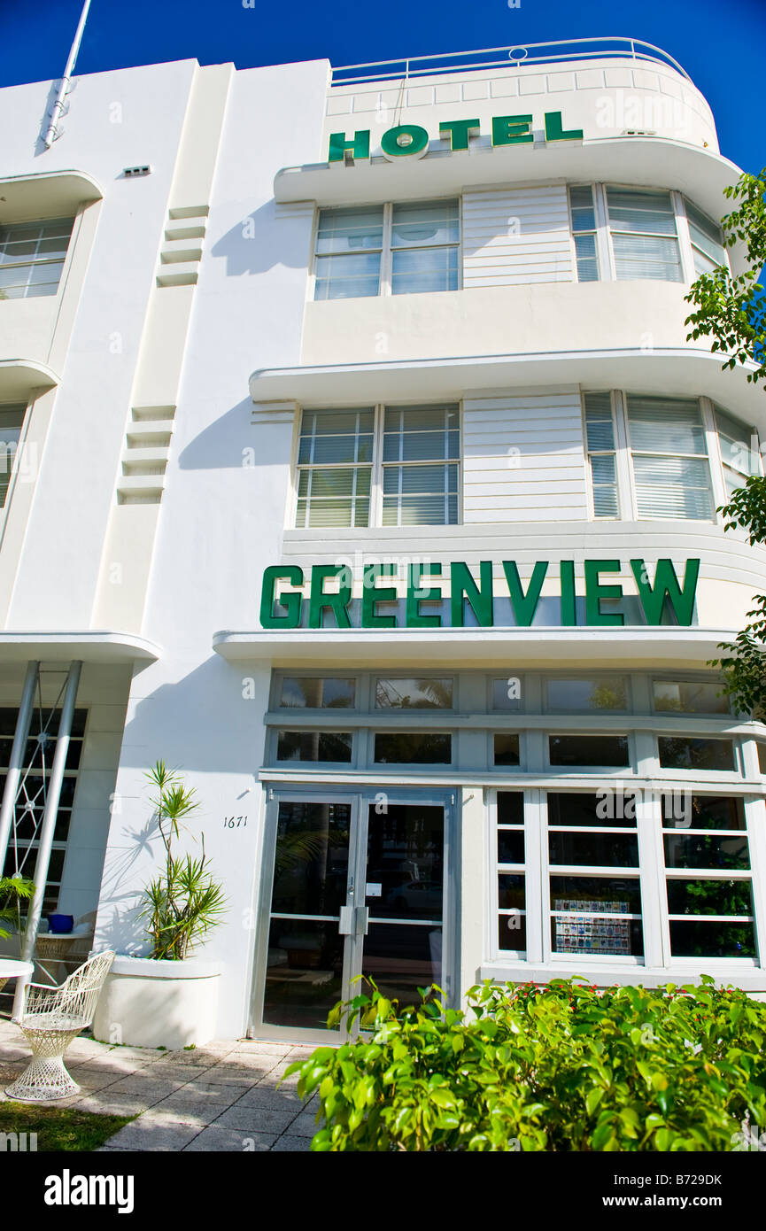 Miami art deco Greenview Hotel 1671 Washington Avenue entrance doors windows flagpole hedge tree planter path chair table Stock Photo