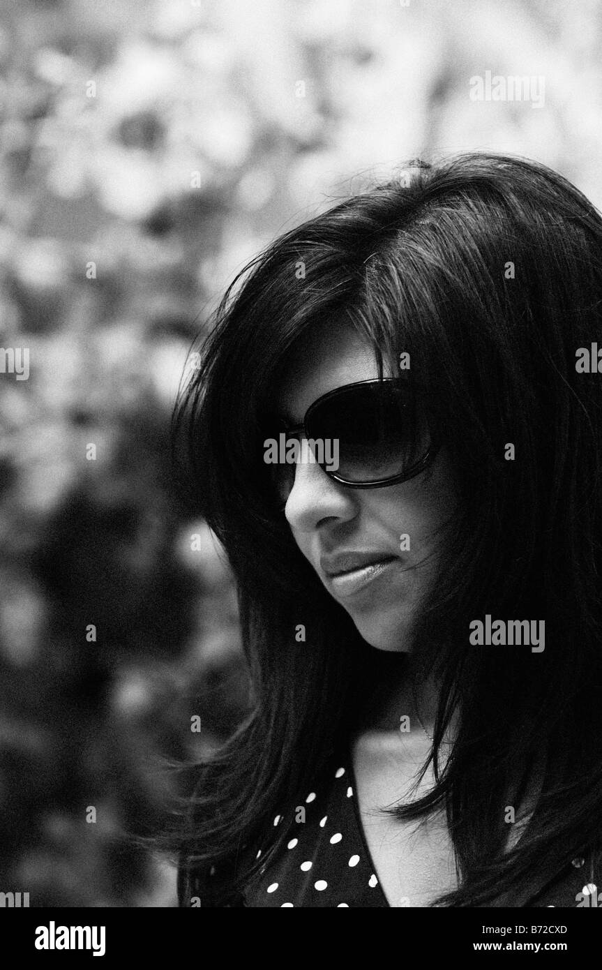 Beautiful young woman wearing sunglasses outdoors Stock Photo