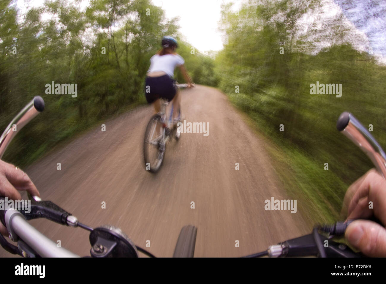 Bike riding off road along a woodland track Stock Photo