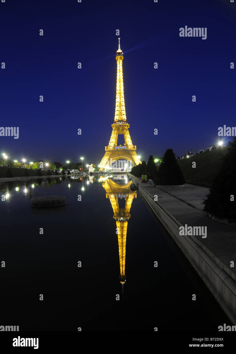 The Eiffel tower illuminated at night and reflected in a pond, in Paris, France. Stock Photo