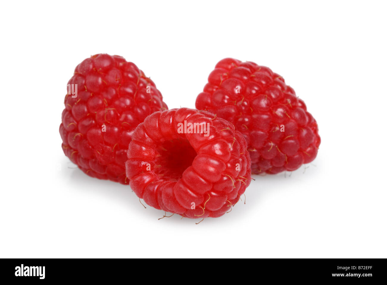 Three red raspberries cut out on white background Stock Photo