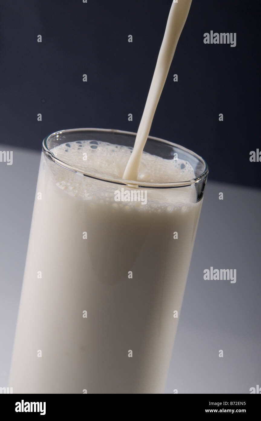 Pouring a Glass of Milk Stock Photo - Alamy