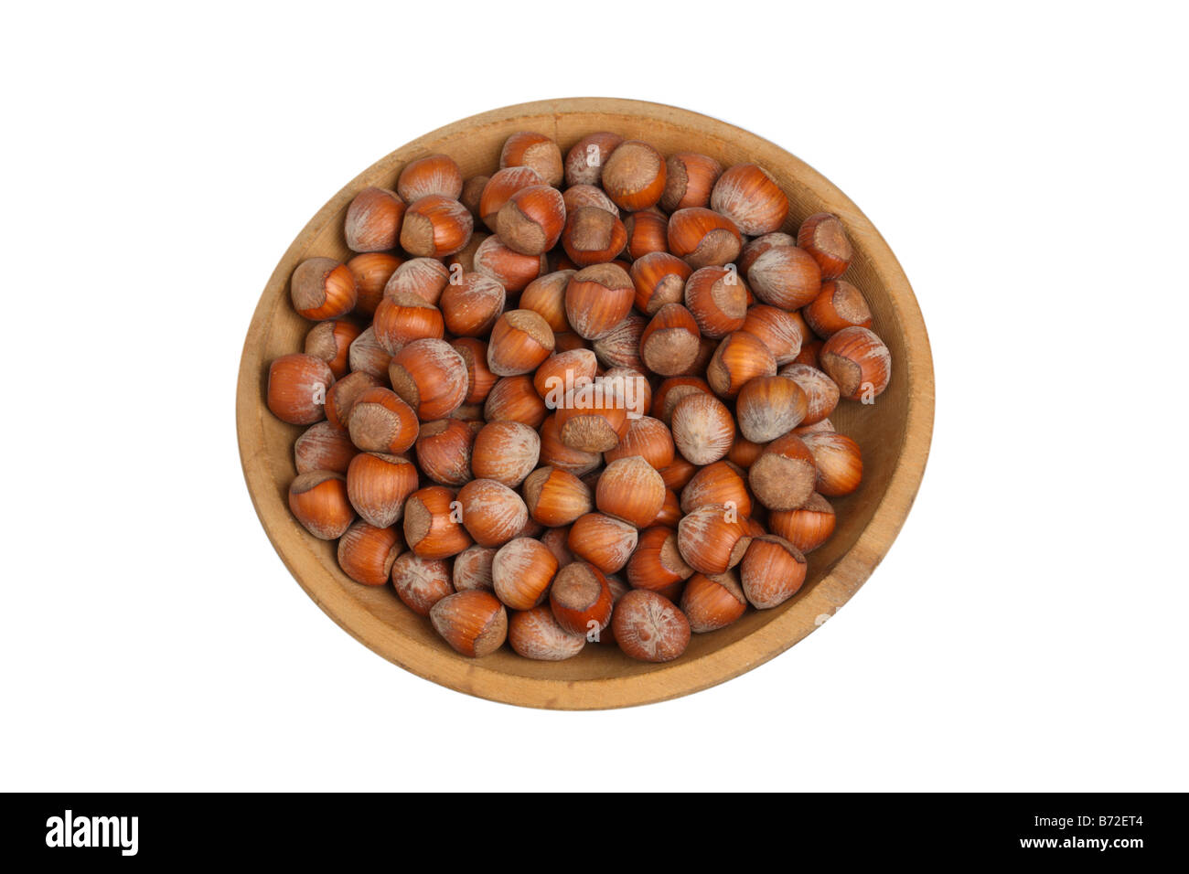 Bowl of hazelnuts cut out on white background Stock Photo