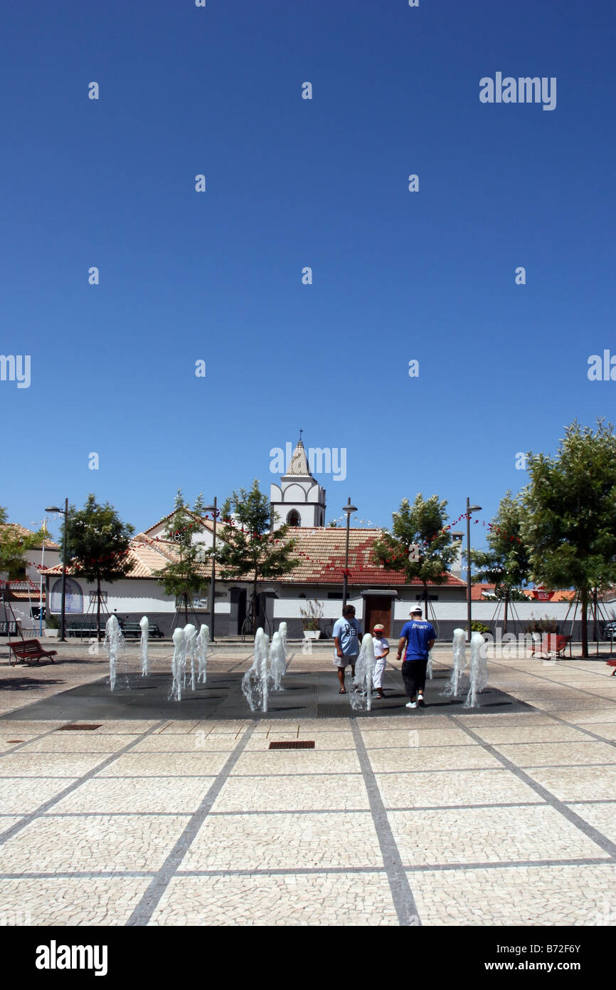 Tourists enjoying the fountain in Jardim do Mar Stock Photo