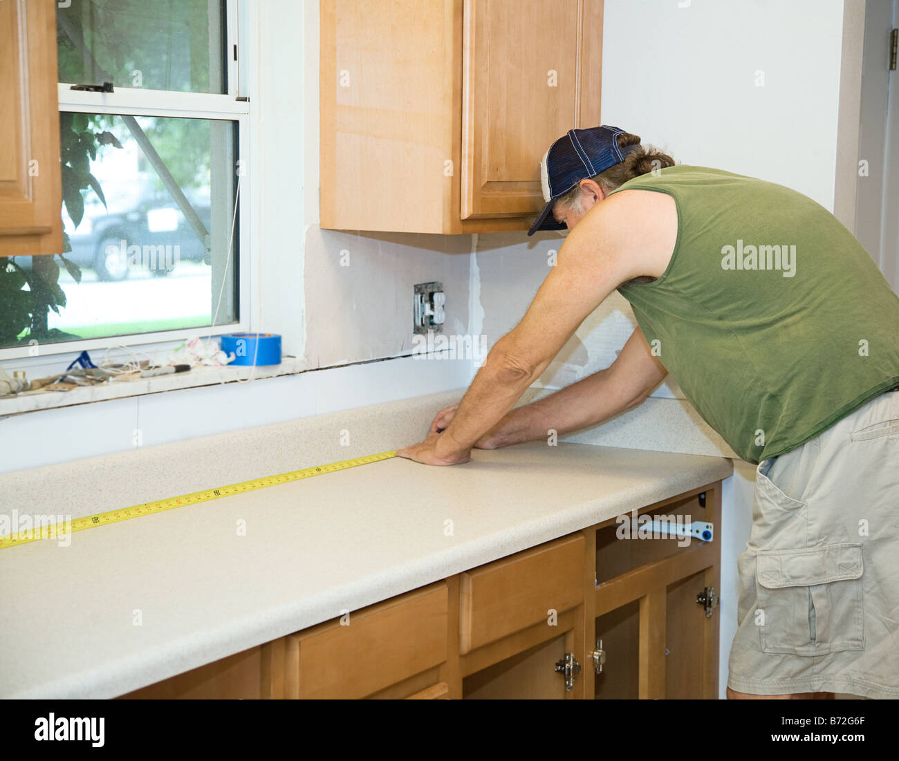 Carpenter Measuring Laminate Counter Top During Kitchen Remodel Stock Photo Alamy