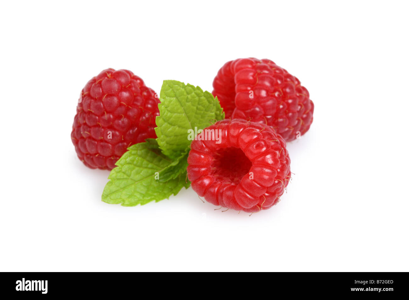 Red raspberries with leaves cut out on white background Stock Photo