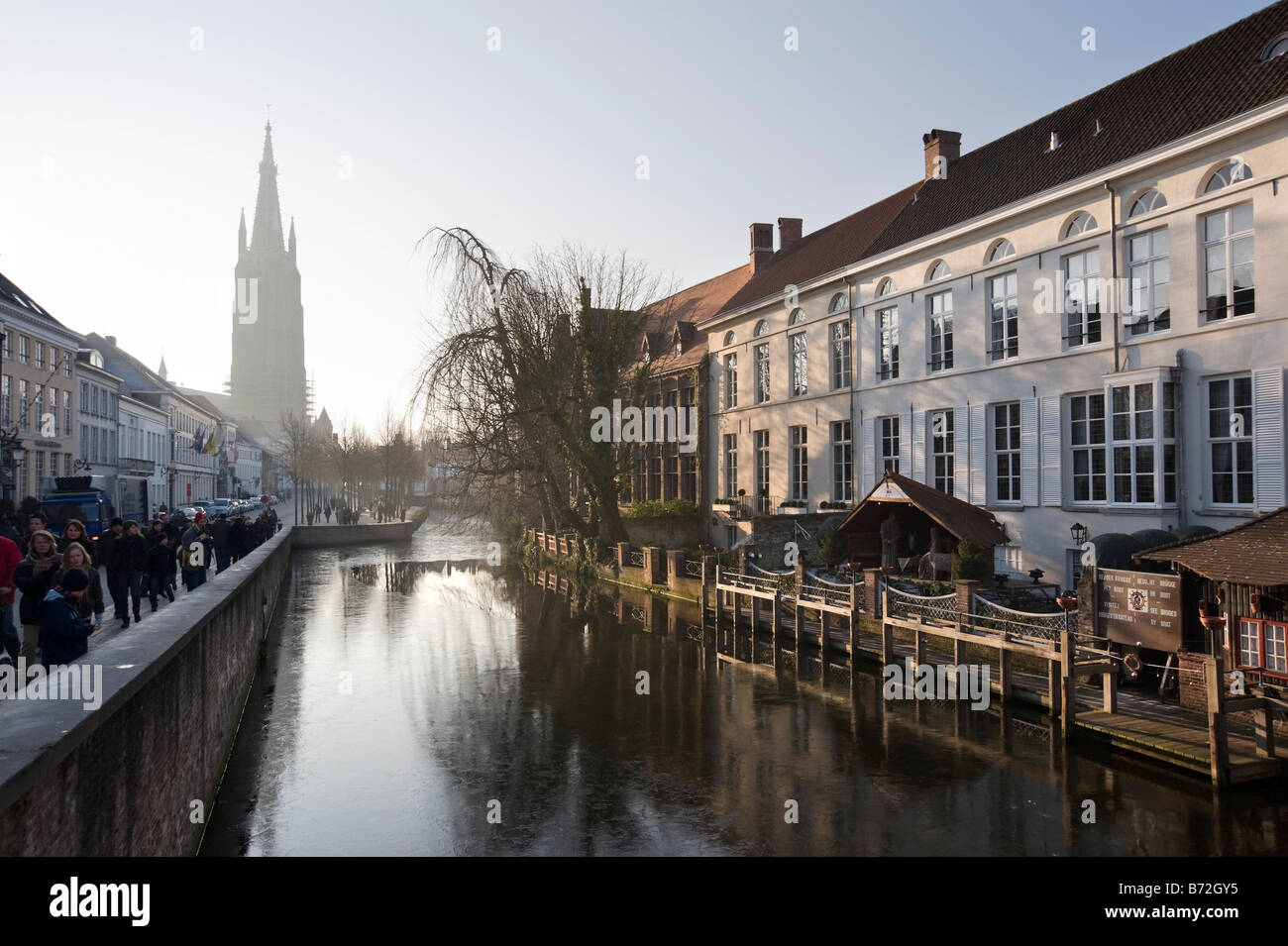 Bruges, Belgium. Winter view of canal and Onze Lieve Vrouwekerk church in the old town centre. Stock Photo