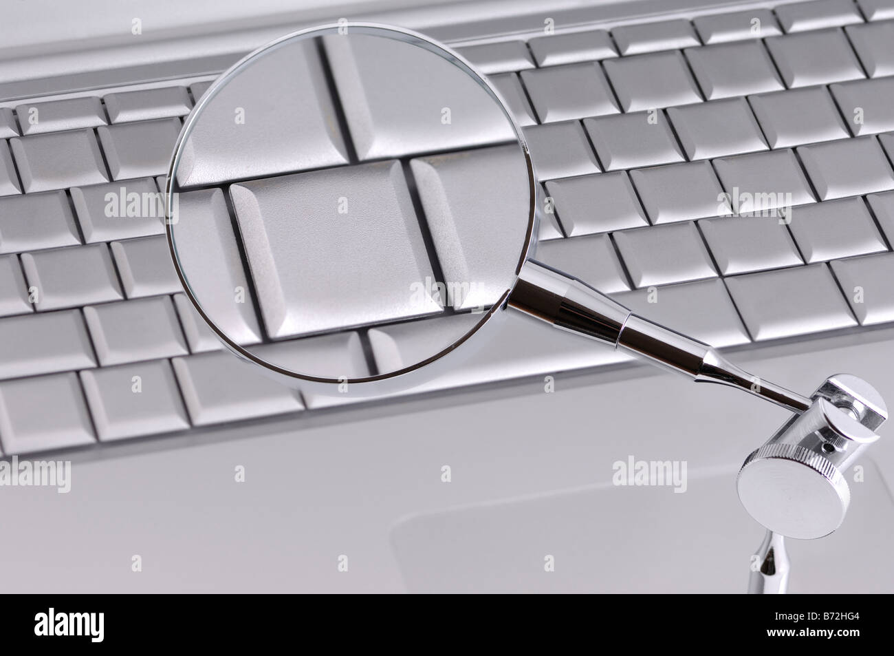 magnifying glass on keyboard of mobile computer Stock Photo Alamy