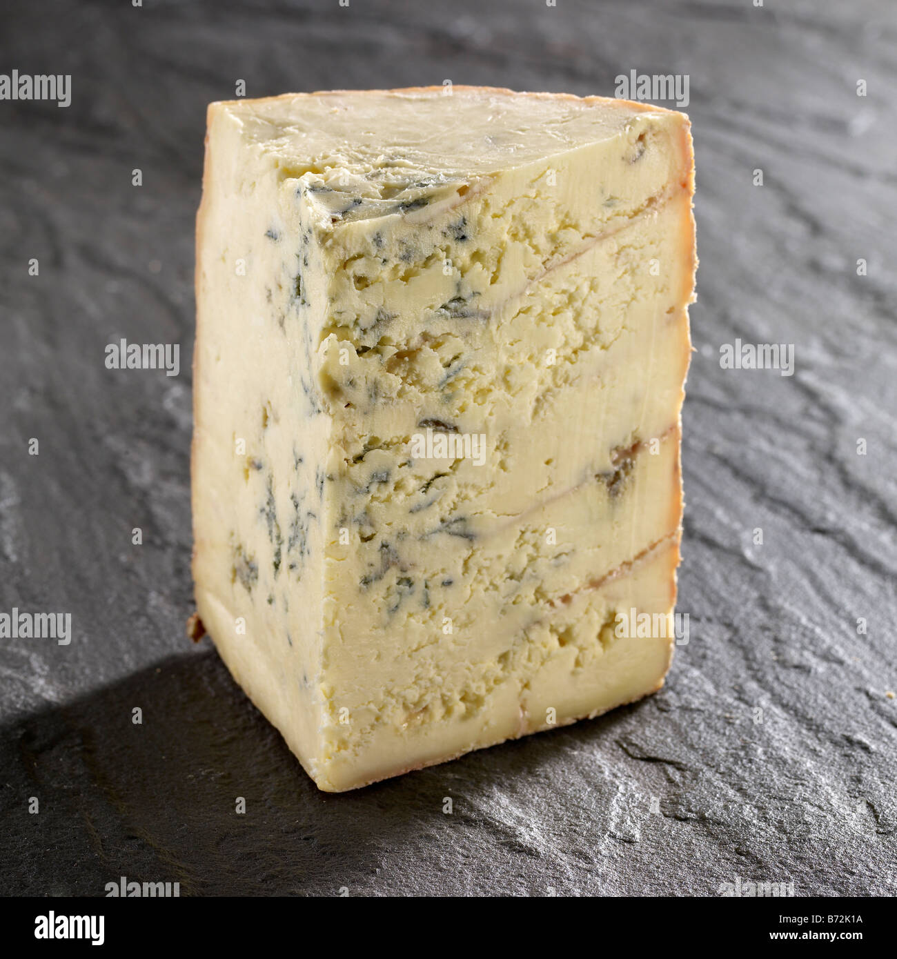 stitchelton cheese wedge on slate Stock Photo