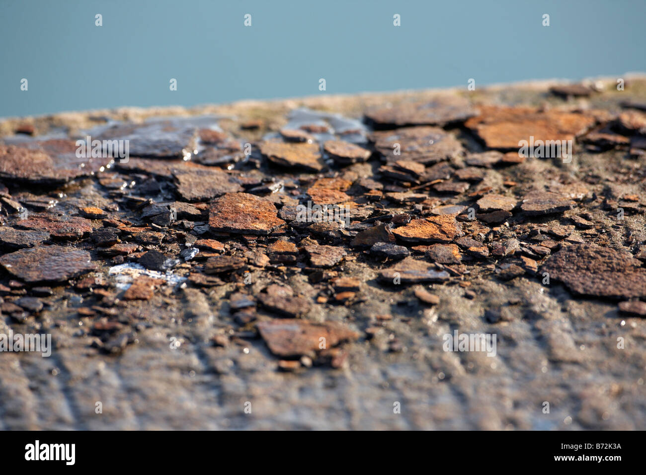 rust flakes lying on a concrete quay county down Northern Ireland UK