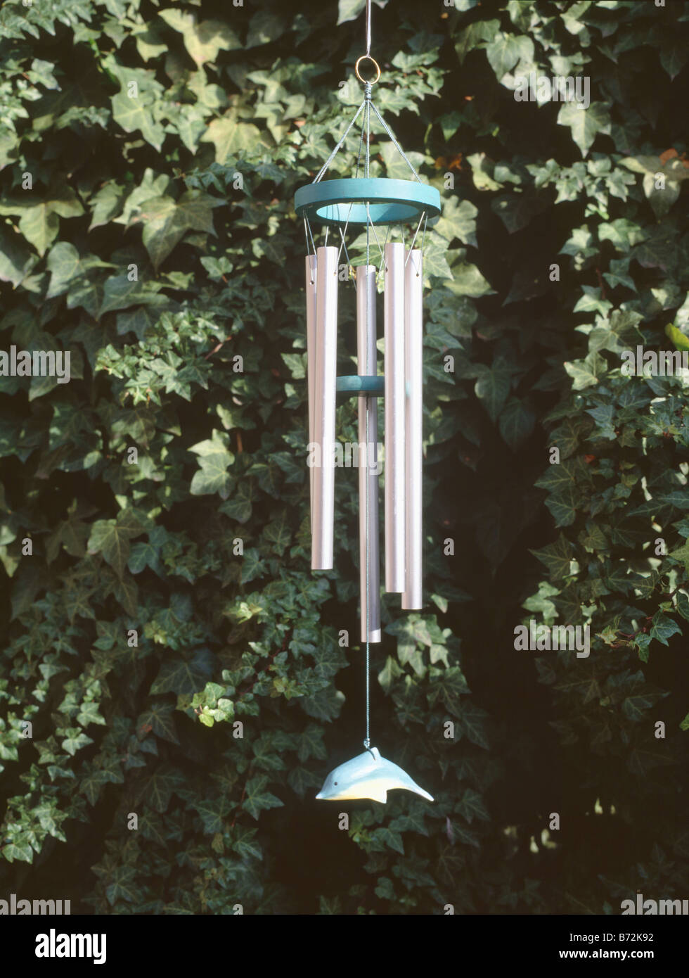 Closeup of metal windchimes in garden Stock Photo Alamy