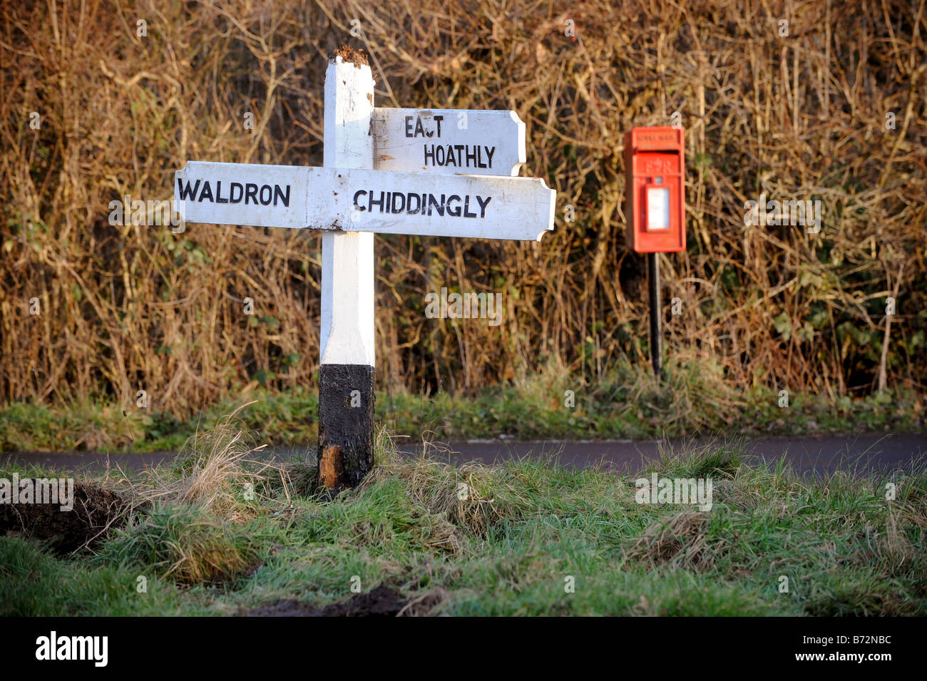 A damaged fingerpost sign which has been nailed back together by local residents Stock Photo