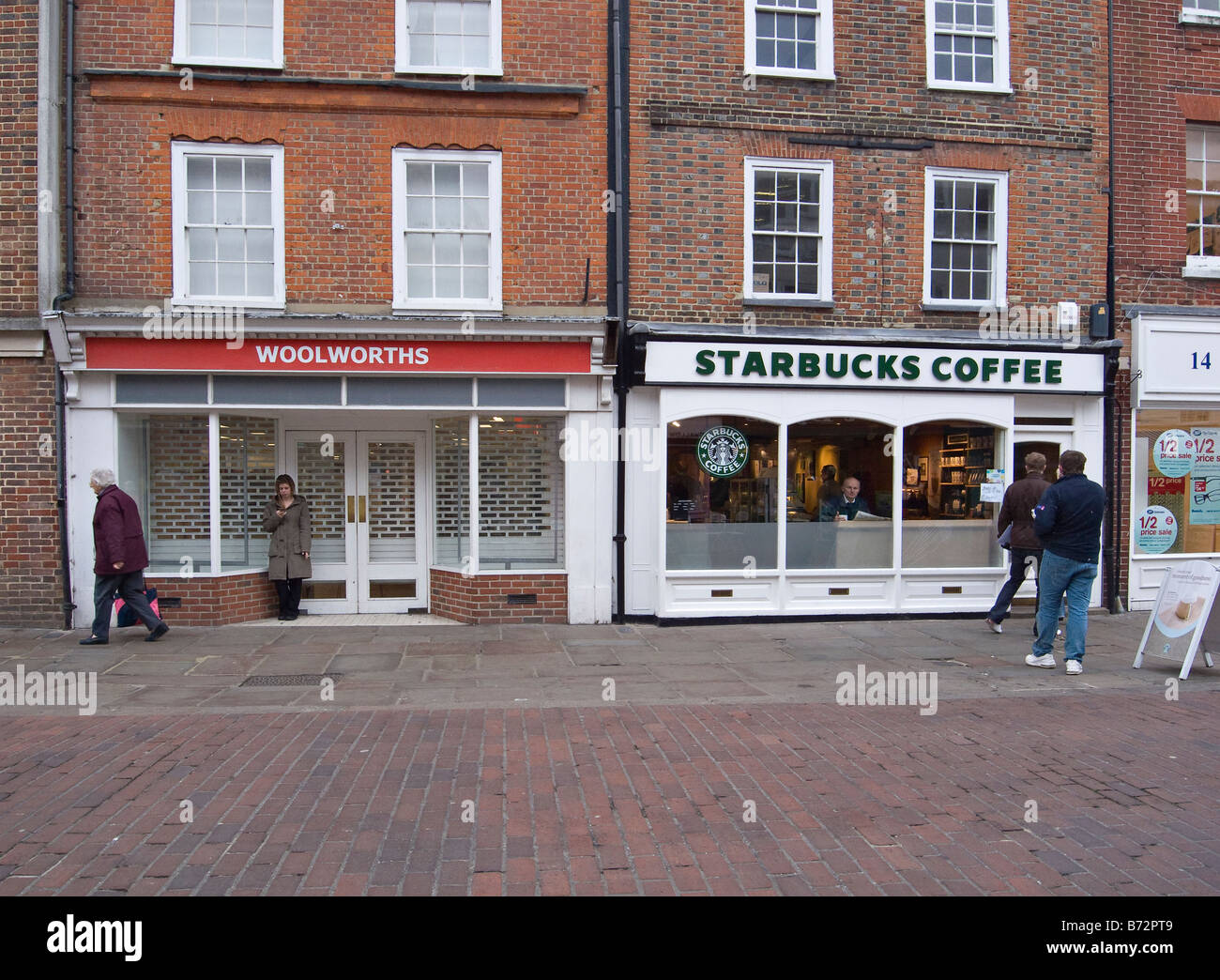 Closed Woolworths store beside Starbucks store. Chichester, West Sussex, UK Stock Photo