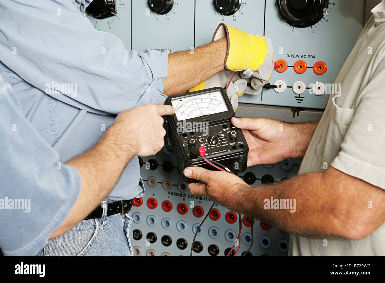 team-of-actual-electricians-testing-the-voltage-on-an-industrial-power-distribution-center-all