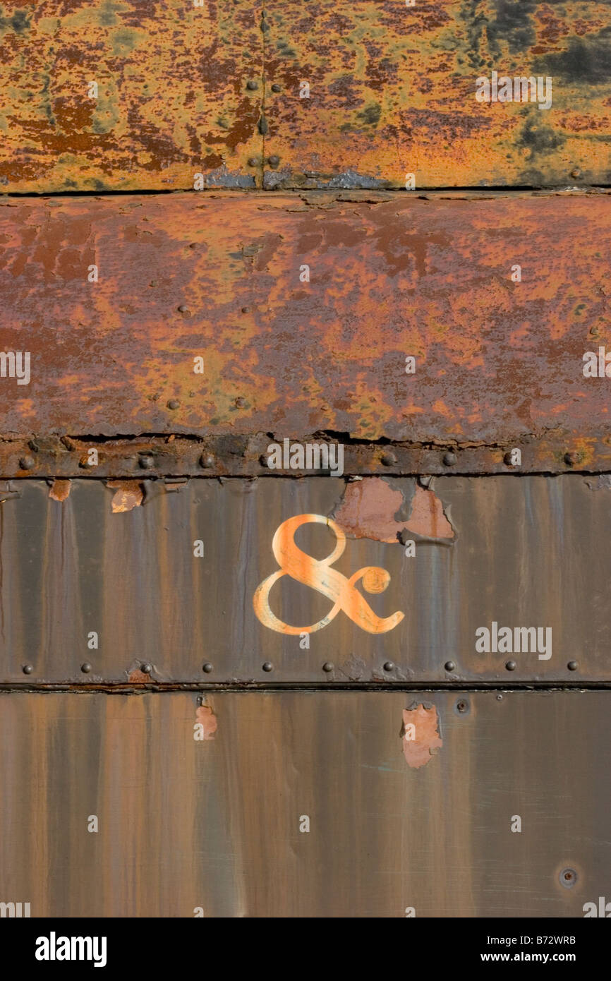 The word symbol & painted on side of old rusty train car Stock Photo