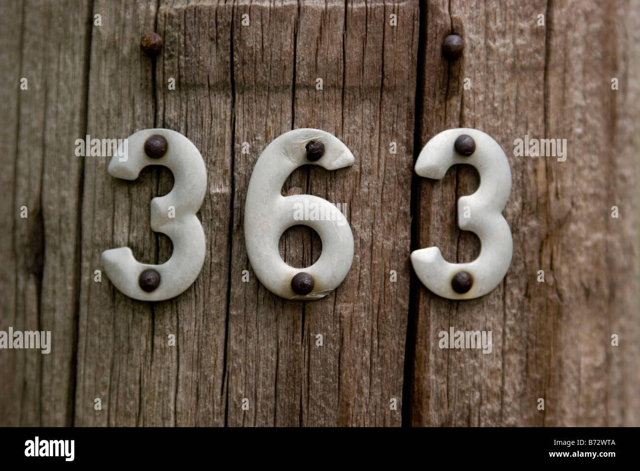Number 363, three hundred sixty three, #363 address on wooden fence post Stock Photo