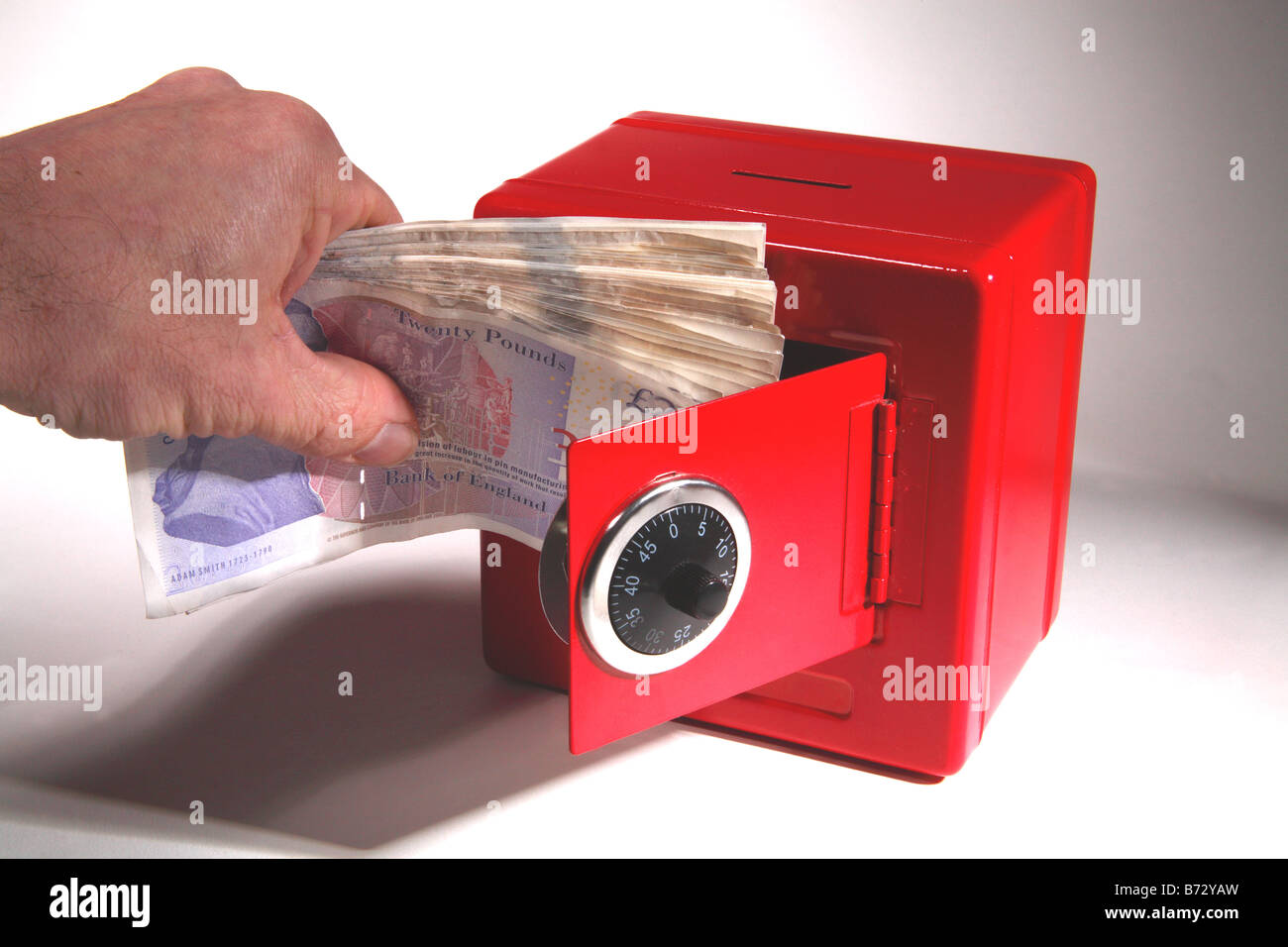 red safe cash money combination credit crunch keeping box bank saving rainy day Stock Photo