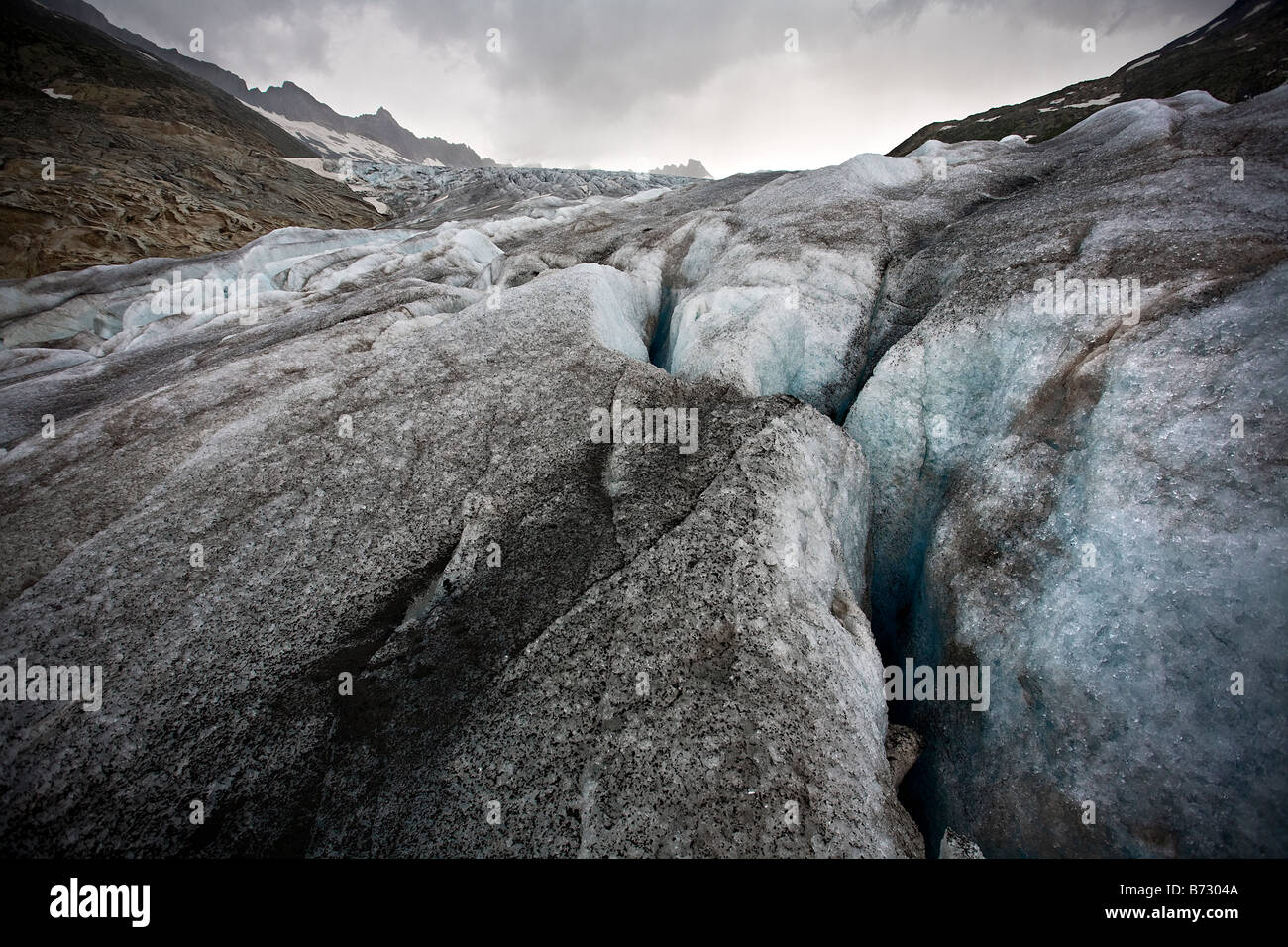 Close up of dirty upper surface of the Rhonegletscher, looking up the glacier, Switzerland Stock Photo