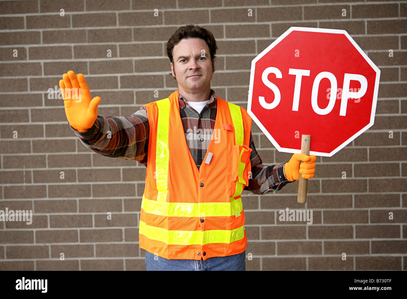 A friendly school crossing guard holding a stop sign Stock Photo - Alamy