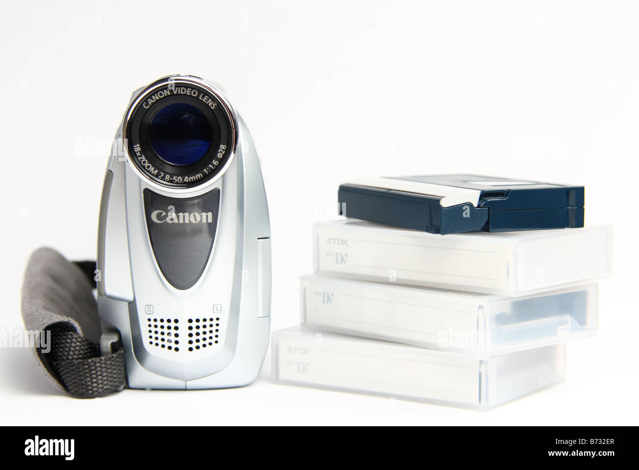 Canon video camera and a pile of video tapes isolated on white